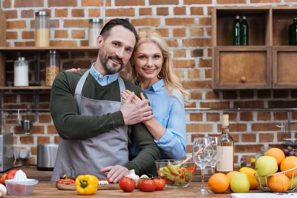 Happy husband and wife holding hands and looking at camera — Stock Photo