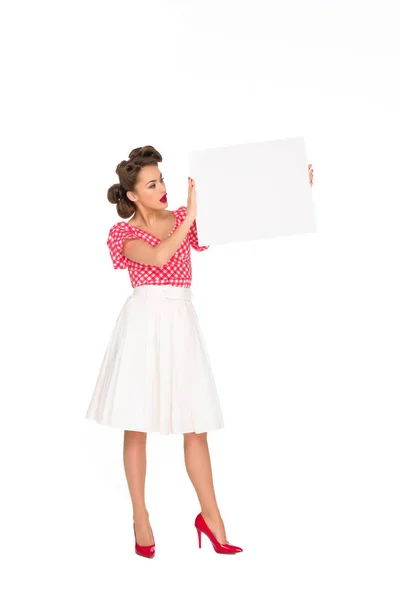 Стильна жінка дивиться на порожній банер в руках ізольовано на білому — стокове фото