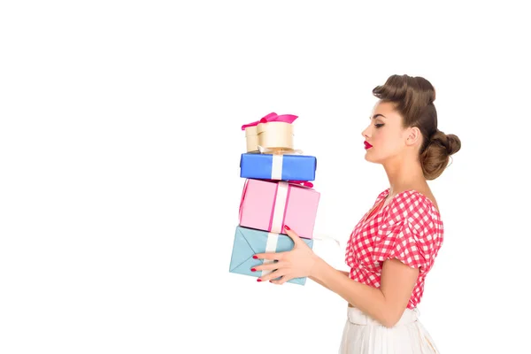 Side view of beautiful woman in retro clothing holding wrapped presents isolated on white — Stock Photo