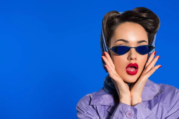 Porträt einer stilvollen Frau in Retro-Kleidung und Sonnenbrille isoliert auf blauem Grund — Stockfoto