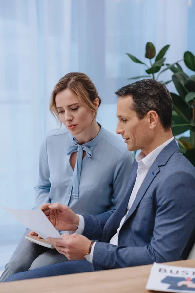 Mature businesspeople doing paperwork together at office — Stock Photo