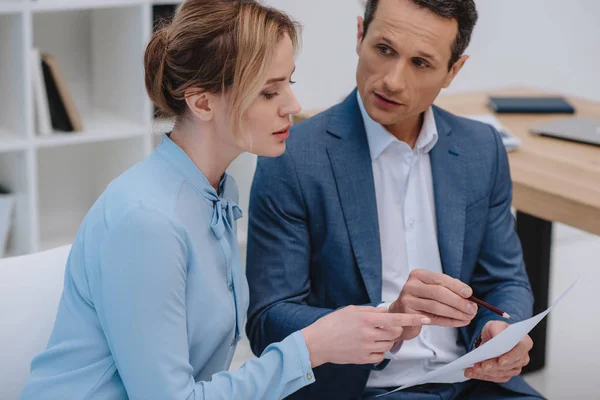 Mature businesspeople discussing documents at office — Stock Photo