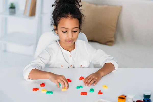 Adorable african american kid learning colored numbers at home — Stock Photo