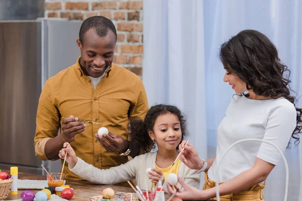 Heureux afro-américain famille peinture Pâques oeufs — Photo de stock