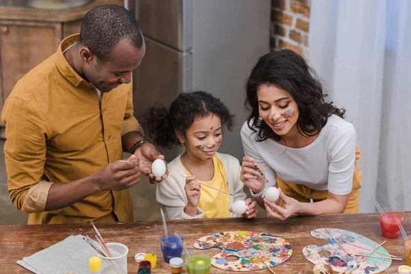 High angle view of african american parents and daughter painting easter eggs — Stock Photo