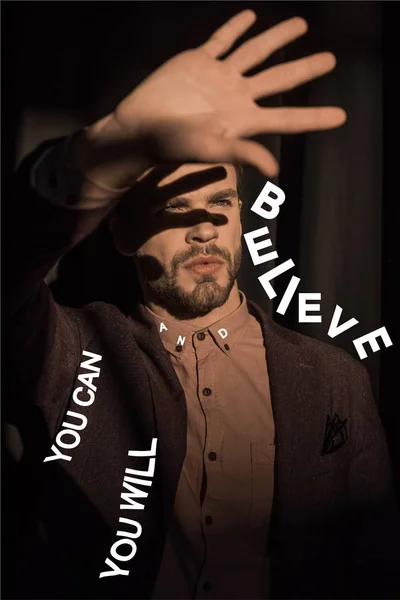 Close-up view of stylish bearded young man showing palm and motivational inscription — Stock Photo