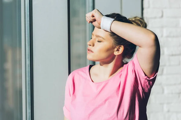 Tired overweight woman with hand on forehead — Stock Photo