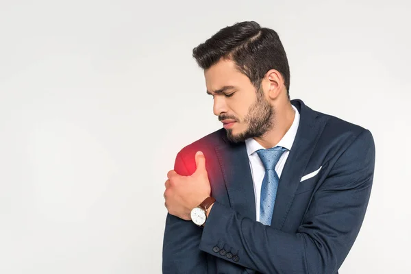 Jungunternehmer leidet an Schmerzen im Arm isoliert auf grau — Stockfoto