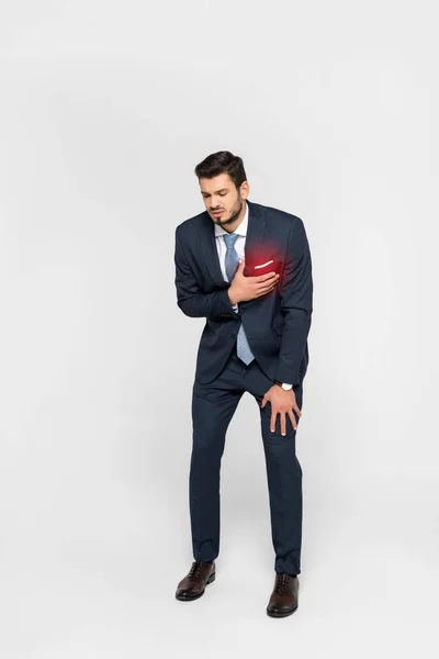 Stressed overworked businessman having heartache isolated on grey — Stock Photo