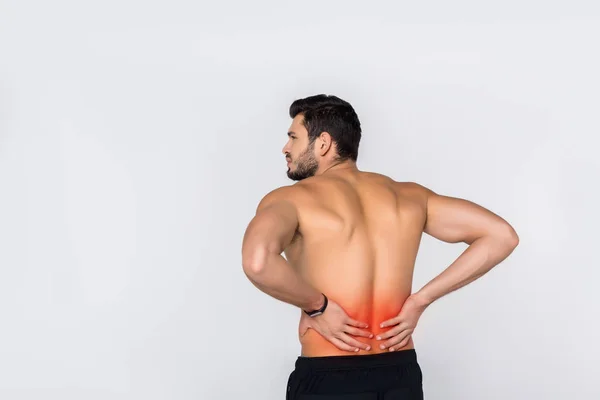 Vista posterior de un hombre joven sin camisa con dolor de espalda aislado en blanco — Stock Photo