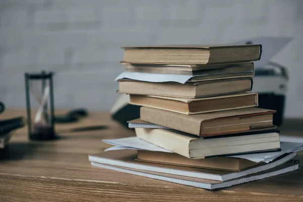 Close-up shot of stacked books on work desk — Stock Photo