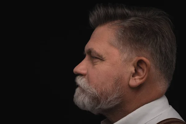 Side view of senior man with stylish beard isolated on black — Stock Photo