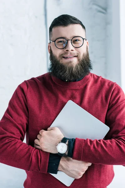 Portrait of stylish smiling businessman with laptop — Stock Photo