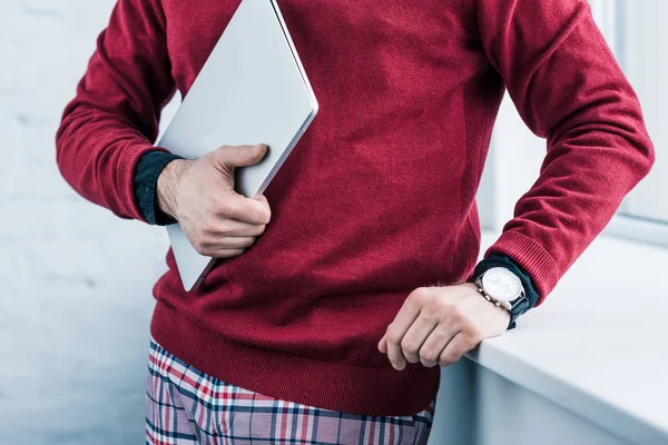 Cropped shot of businessman holding laptop in hand — Stock Photo