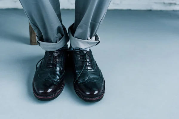 Partial view of businessman in stylish black shoes — Stock Photo