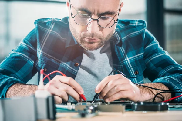 Male engineer testing circuit board — Stock Photo
