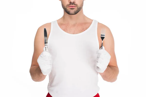Обрезанный вид человека, держащего вилку и нож изолированы на белой, пасхальной концепции — стоковое фото
