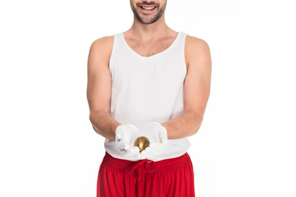 Cropped view of young man holding golden egg isolated on white, easter concept — Stock Photo