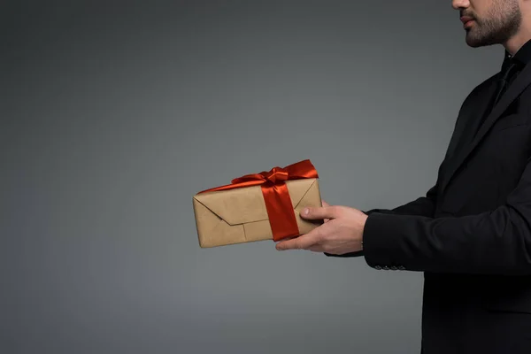 Cropped view of male holding gift box isolated on grey, international womens day concept — Stock Photo