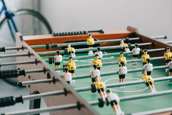 Table soccer and bicycle in living room — Stock Photo