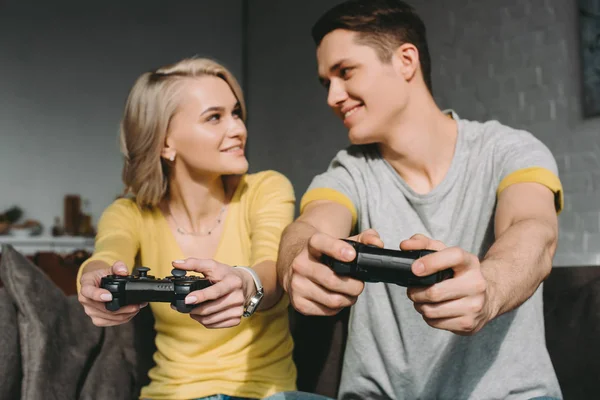 Couple playing video game and looking at each other — Stock Photo