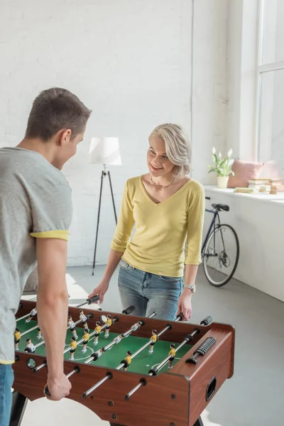 Happy couple playing foosball at home — Stock Photo
