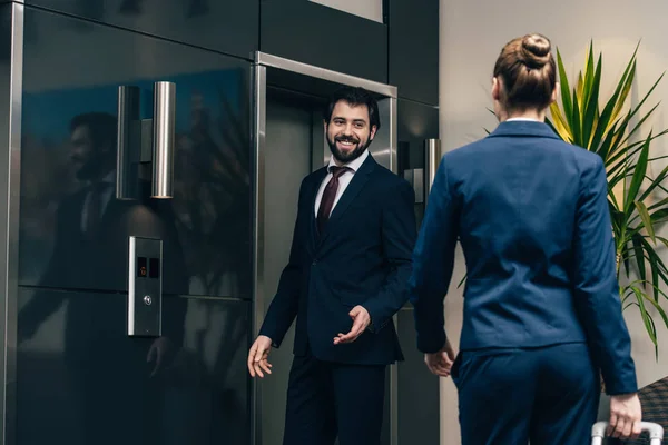 Business people waiting for elevator together — Stock Photo