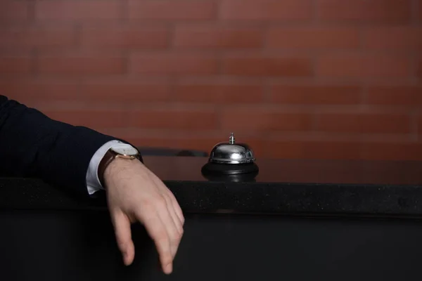 Cropped shot of businessman leaning on hotel reception desk — Stock Photo