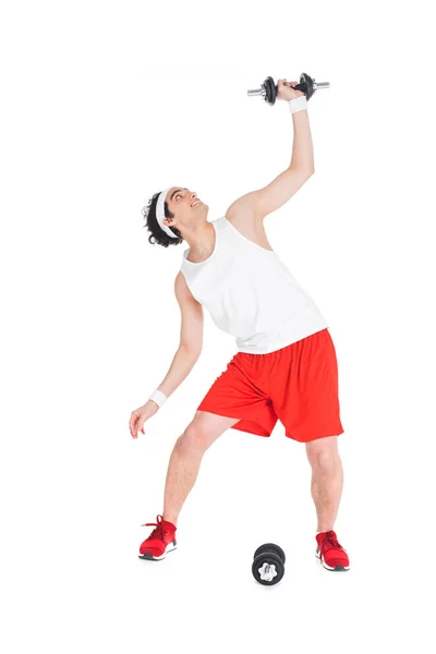 Joven hombre delgado en ropa deportiva sosteniendo mancuernas aisladas en blanco — Stock Photo