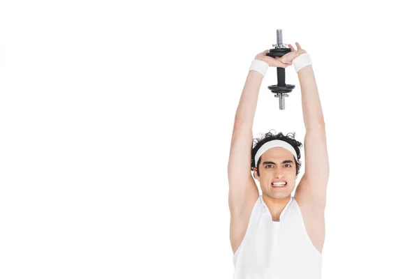 Young skinny man holding dumbbell over own head — Stock Photo