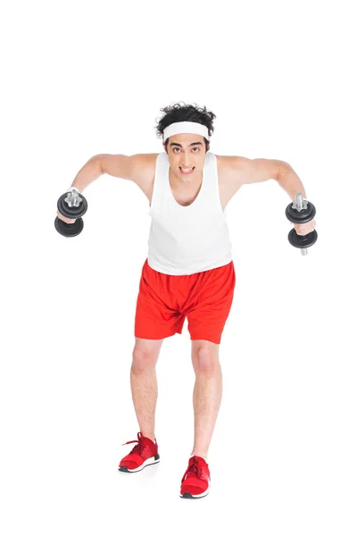 Jeune homme mince en vêtements de sport faisant de l'exercice avec des haltères isolés sur blanc — Photo de stock