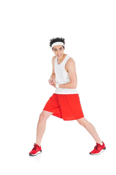 Young skinny sportsman showing muscles on hand isolated on white — Stock Photo