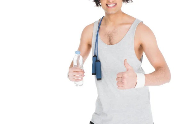 Cropped view of smiling thin sportsman with jump rope and bottle of water isolated on white — Stock Photo