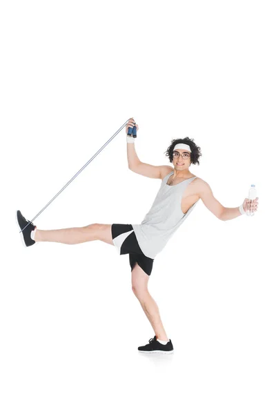 Skinny sportsman in eyeglasses with jump rope and bottle of water isolated on white — Stock Photo