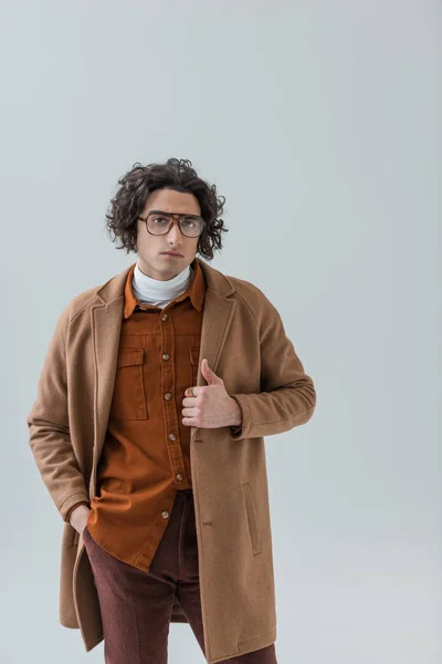 Portrait of young stylish man in eyeglasses isolated on grey — Stock Photo