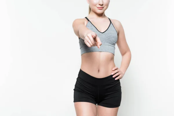 Cropped view of sportswoman pointing at camera isolated on white — Stock Photo