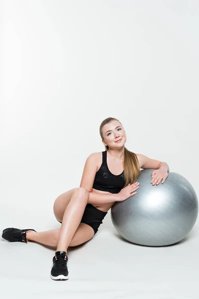 Attractive sportswoman by fitness ball isolated on white — Stock Photo