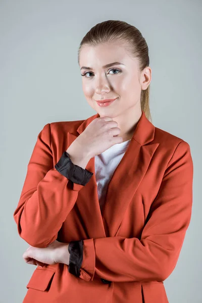 Smiling attractive blonde woman isolated on grey — Stock Photo