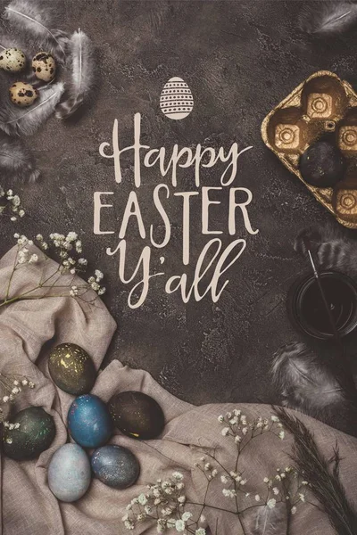 Top view of easter eggs, golden tray, flowers, paint and brush on cloth with Happy Easter you all lettering — Stock Photo