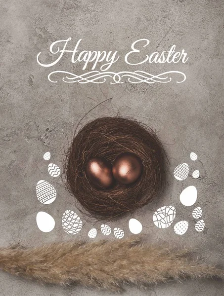 Top view of golden easter eggs in nest on concrete surface with Happy Easter lettering — Stock Photo