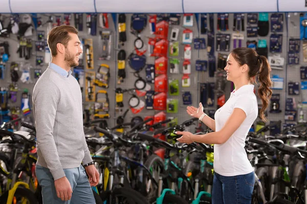 Side view of seller and customer talking in bicycle shop — Stock Photo