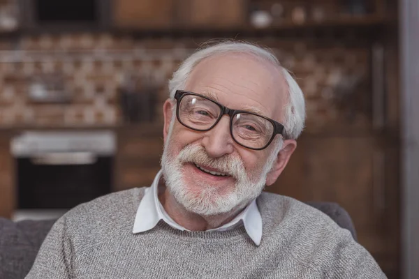 Portrait of smiling grey hair man looking at camera at home — Stock Photo