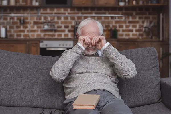 Handsome grey hair man rubbing eyes at home — Stock Photo