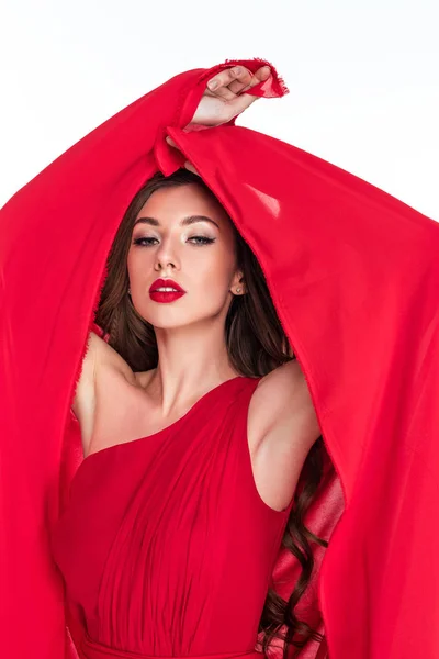 Sensual woman posing in red dress with veil, isolated on white — Stock Photo