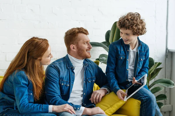 Son showing tablet to his father and mother — Stock Photo