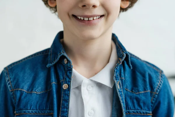 Close-up view of smiling little child wearing shirt and jacket — Stock Photo