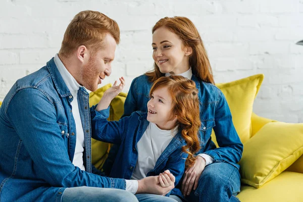 Cute family parents and child embracing at home — Stock Photo
