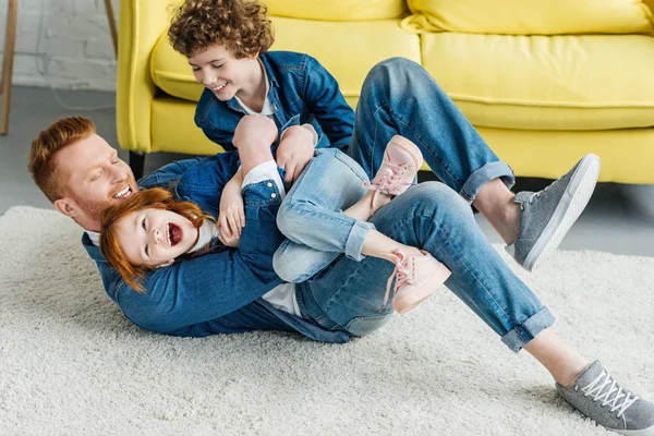 Father with children fooling around in the floor — Stock Photo