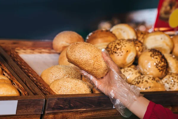 Partial view of shopper choosing loaf of bread in store — Stock Photo