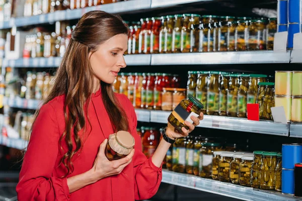 Portrait of attractive woman choosing products in hypermarket — Stock Photo